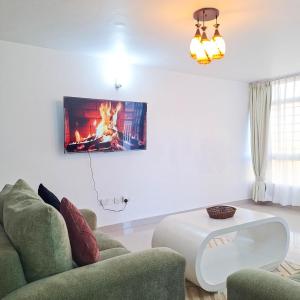 a living room with a couch and a table at Zerani Homes in Ruaka