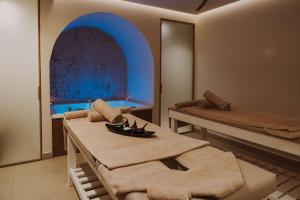 a room with two beds and a table in it at Bali Star Resort Hotel in Bali