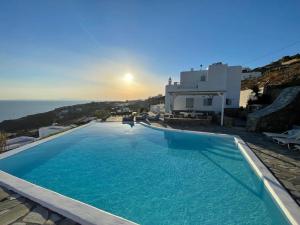 a large swimming pool with a view of the ocean at Luxury Villa Dorothea Mykonos in Fanari