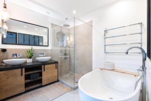 a bathroom with a tub and two sinks and a shower at Villa cosy Paris in La Garenne-Colombes +66 photos
