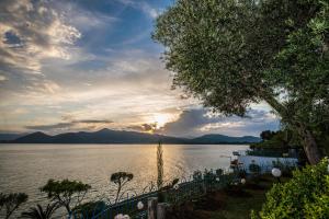 a view of a body of water with a sunset at Cliff Bay Hotel by GHH in Paleros