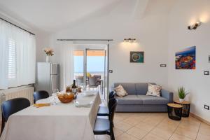 a dining room with a table and a couch at Apartments Sunset in Vodnjan