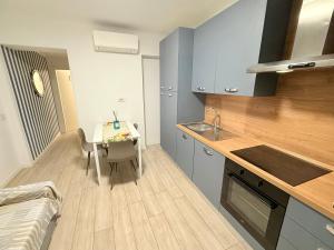 a kitchen with a table and a small kitchen with a tableablish at Colombo 365 in Civitanova Marche