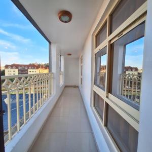 a balcony with windows and a view of the water at Zerani Homes in Ruaka