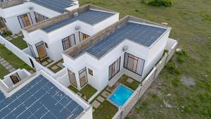 an overhead view of a house with solar panels on its roof at Nook Villas in Bagamoyo
