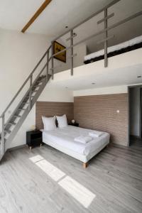 a bedroom with a large bed and a staircase at La Maisonette à Lacrost in Lacrost