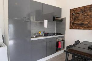 a kitchen with a sink and a stainless steel refrigerator at La Maisonette à Lacrost in Lacrost +10 photos