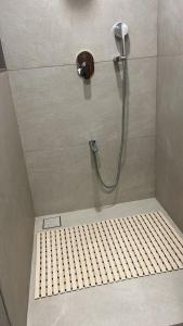 a shower in a bathroom with a shower head at Dhiraj Dham in Nāthdwāra