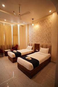 a hotel room with two beds in a room at Hotel JMS Grand in Jaunpur +50 photos