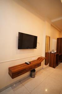 a flat screen tv hanging on a wall at Hotel JMS Grand in Jaunpur