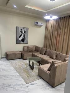 a living room with a couch and a table at De Ark Inn hotel in Port Harcourt