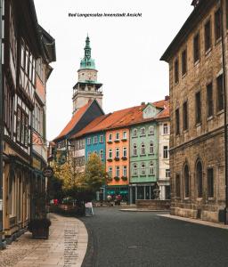 a city street with buildings and a clock tower at Ferienhaus Ringelwiese in Schönstedt
