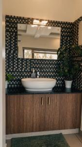 a bathroom with a sink and a mirror at Willostays Tamarind beach villa in Cherai Beach +44 photos