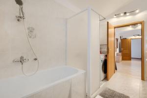 a white bathroom with a tub and a shower at Apartments Sunset in Vodnjan +129 photos