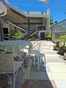 a patio with a table and chairs on a patio at D Estelita Guest House in Moalboal +34 photos