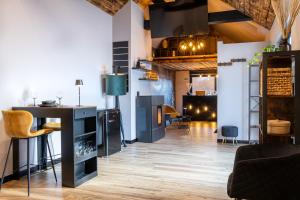 a living room with a bar and a table at Osé in Chênet