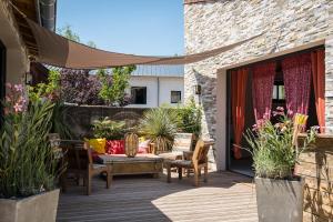 a patio with chairs and a table on a deck at Magnifique domaine avec piscine in Montréal