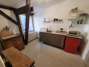 a small kitchen with a sink and a microwave at Kranich in Ueckermünde