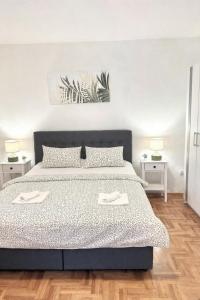 a bedroom with a bed with two towels on it at Apartment Olivia in Šmrika
