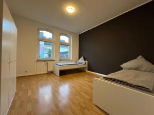 a bedroom with a bed and a bench in it at Living - Ferien & Monteur Appartement in Wuppertal
