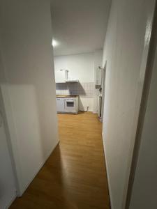 an empty room with a kitchen and a hallway at Living - Ferien & Monteur Appartement in Wuppertal