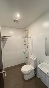 a white bathroom with a toilet and a sink at Hotel 801 in Cagayan de Oro +12 photos