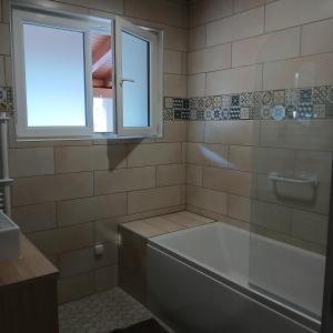 a bathroom with a tub and a window at La D'homette in Fresse-sur-Moselle +31 photos