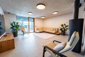 a large living room with a couch and chairs at The Alpine House Otto in Begunje na Gorenjskem +18 photos