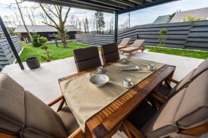 a wooden table and chairs on a patio at The Alpine House Otto in Begunje na Gorenjskem