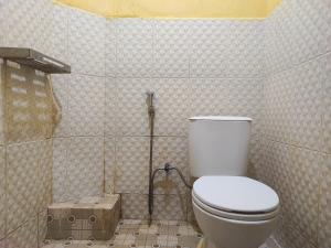 a bathroom with a toilet and a shower in it at RedDoorz Syariah At Hotel Matahari 1 Jambi in Jambi