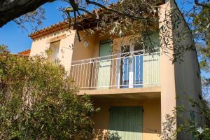 a building with a balcony on the side of it at La villa Cigaliere in Tulette