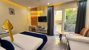 a hotel room with a bed and a living room at Roots & Peaks Wellness Hotel in Rishīkesh