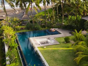 an overhead view of a swimming pool in a garden at K Ko Surf Village at Keramas in Lebih +32 photos