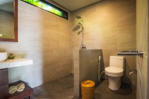 a bathroom with a toilet and a sink at K Ko Surf Village at Keramas in Lebih