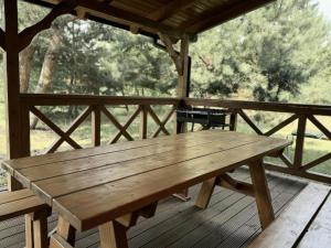 a wooden picnic table sitting on a porch at Domki w Lipnicy in Lipnica