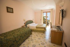 a hotel room with two beds and a sink at Hotel Terme Saint Raphael in Barano d'Ischia