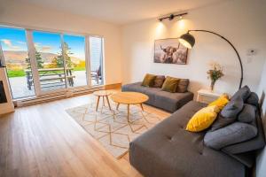 a living room with a couch and a table at Chic Condo - Stunning View & Quiet in Baie-Saint-Paul