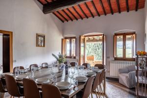 a large dining room with a long table and chairs at Podere le Lune with Pool, San Gimignano in San Gimignano +62 photos