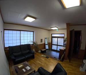 a living room with a couch and a table at Tsumugu dom in Ueda