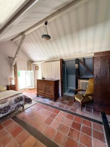 a bedroom with a bed and a desk and a chair at Lorcival in Savennières