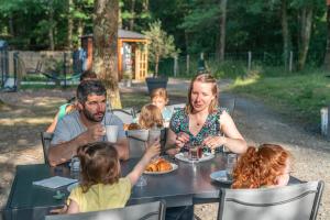 a group of people sitting at a table eating food at La Parenthèse Meslandaise in Mesland +92 photos