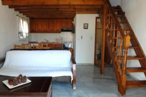 a bedroom with a white bed and a staircase at Sigrion Villas in Sígrion