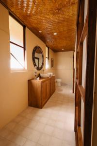 a bathroom with a sink and a mirror at Fare Teiti Beach Bungalow in Haapiti