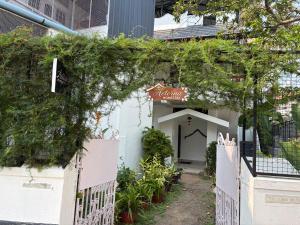 a small white building with a sign on it at AETERNA Homestay in Fort Kochi +3 photos