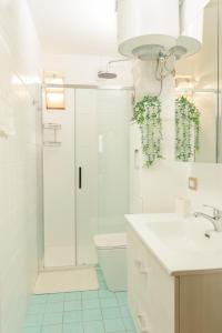a bathroom with a shower and a toilet and a sink at SHARED SWIMMING POOL, House relax Lu Bagnu in Castelsardo