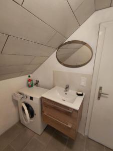 a bathroom with a sink and a mirror at Idyllisches Landhaus in Grasberg +50 photos