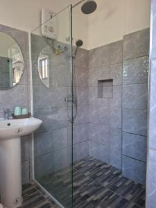 a bathroom with a shower and a sink at D Estelita Guest House in Moalboal