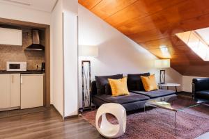 a living room with a couch and a table at Suite Prado in Madrid