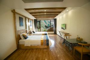 a bedroom with a bed and a desk in a room at Mountain-scenery inn in Zhangjiajie +150 photos