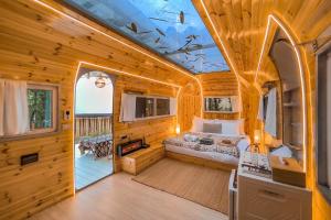 a bedroom in a log cabin with a bed in it at La Lanna in Ban Pok Nai
